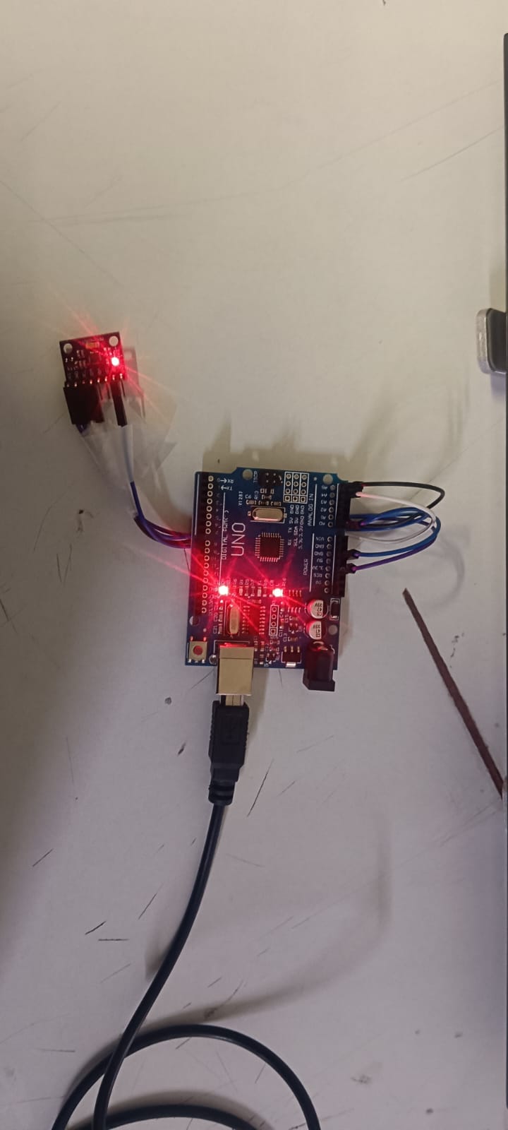 A circuit board with glowing red lights