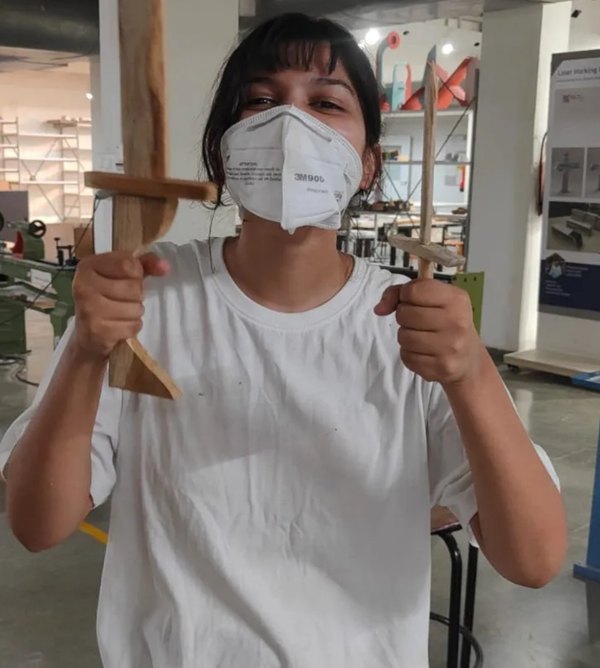Siddhi holding two wooden swords